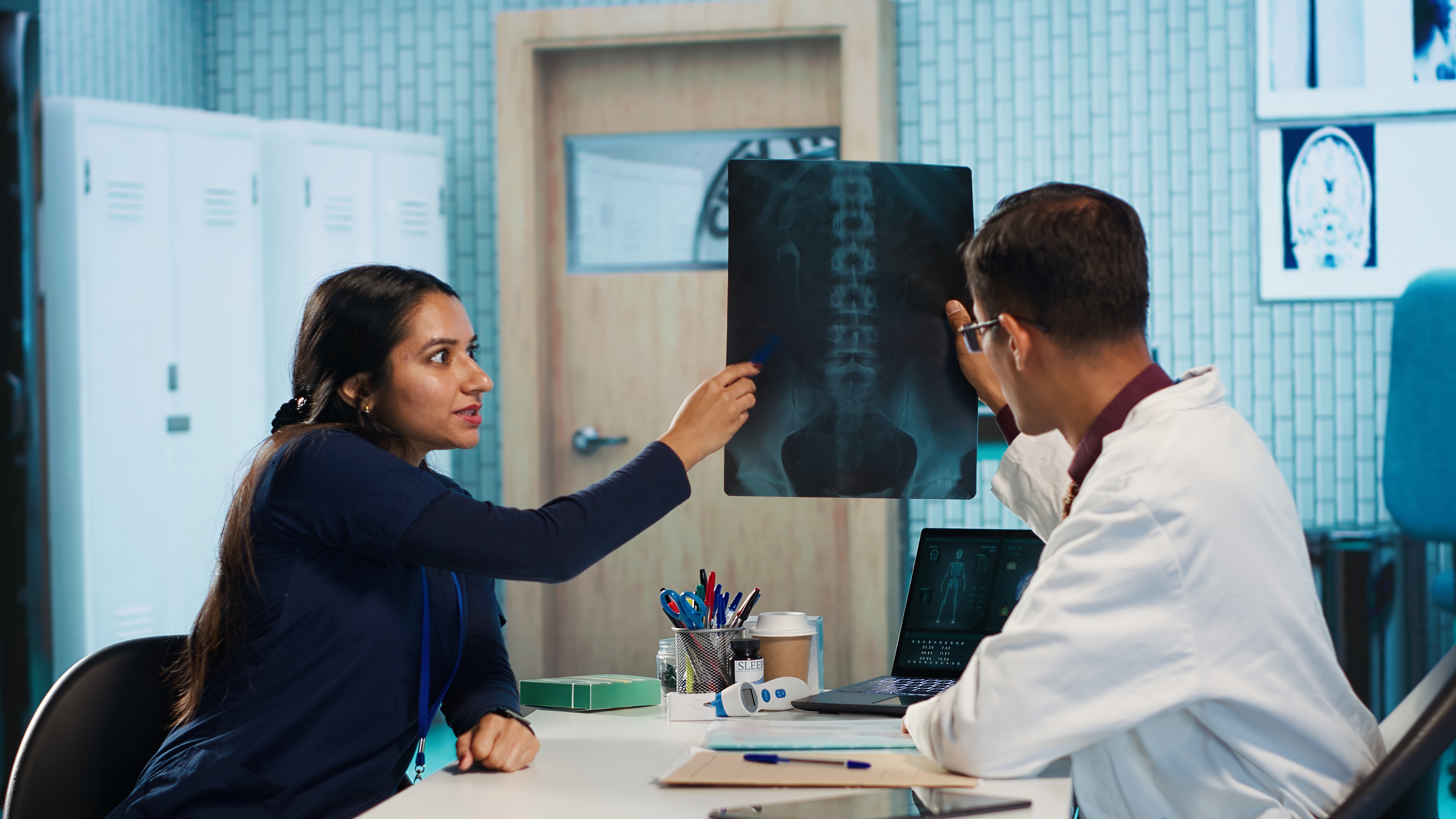 Doctors reviewing a spine X-ray
