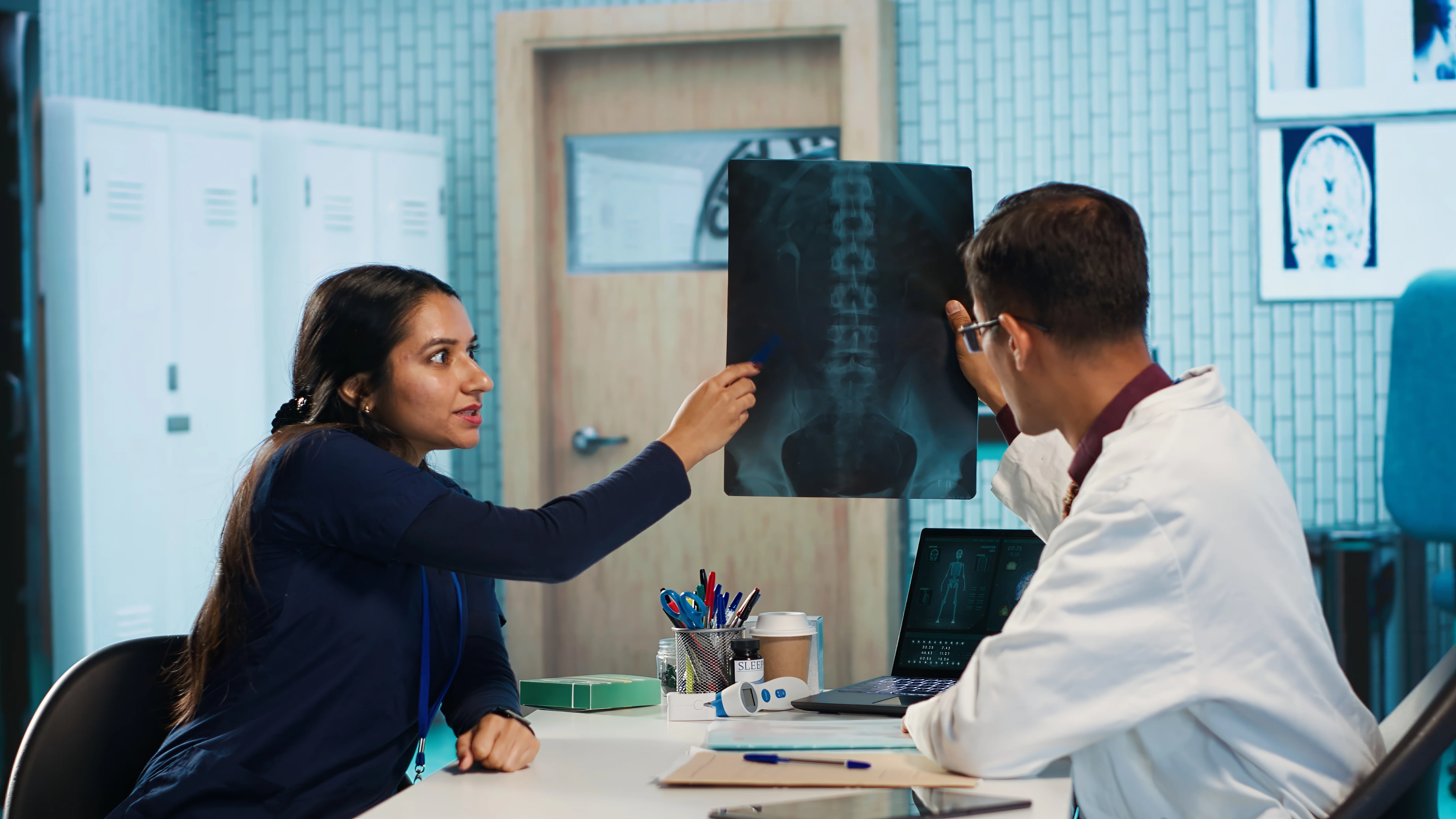 Doctors reviewing a spine X-ray